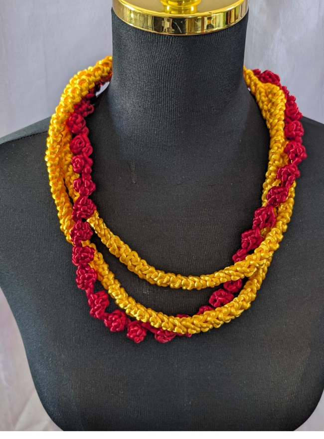 Maroon and green ti-leaf style ribbon lei with white crochet accent